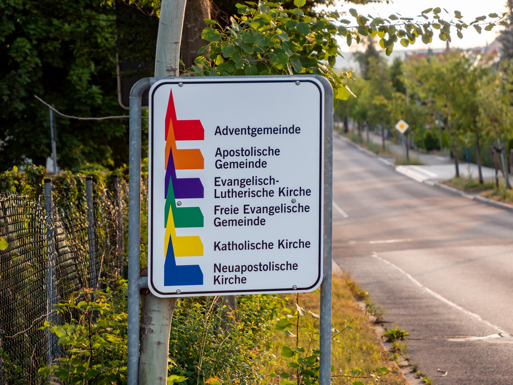 Radeberg, road sign with different churches and different Christian denominations in Saxony. Every little church icon has its own color. The information is for tourists.